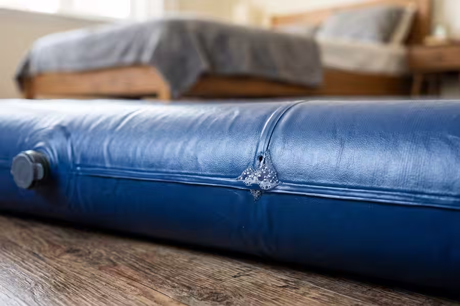 A small leak along the seam of a vinyl air mattress
