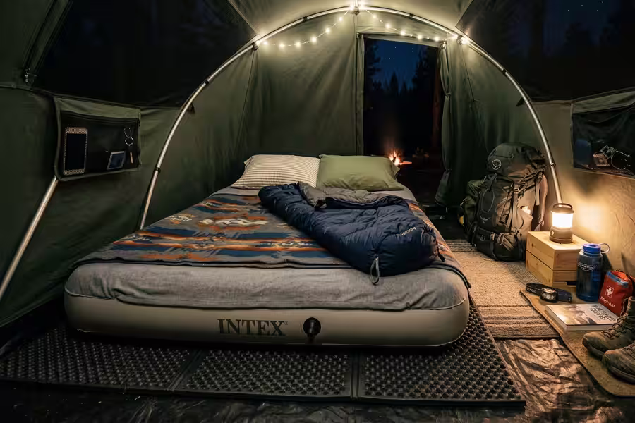 optimal air mattress placement on protective tarp inside camping tent